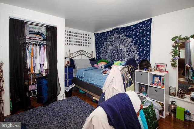 a bed room with a bed and a book shelf
