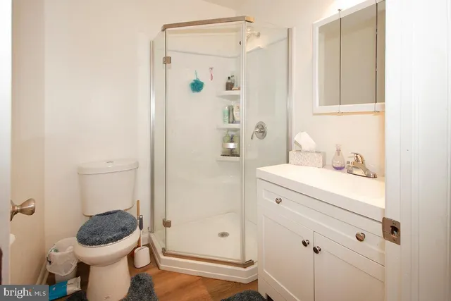 a bathroom with a granite countertop toilet sink and shower
