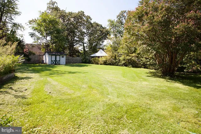 a view of swimming pool is middle in the garden