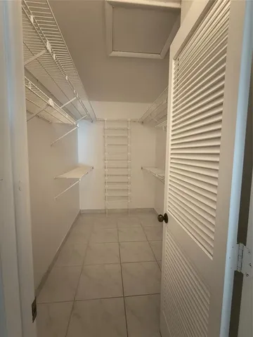 a bathroom with a sink a toilet a mirror and shower