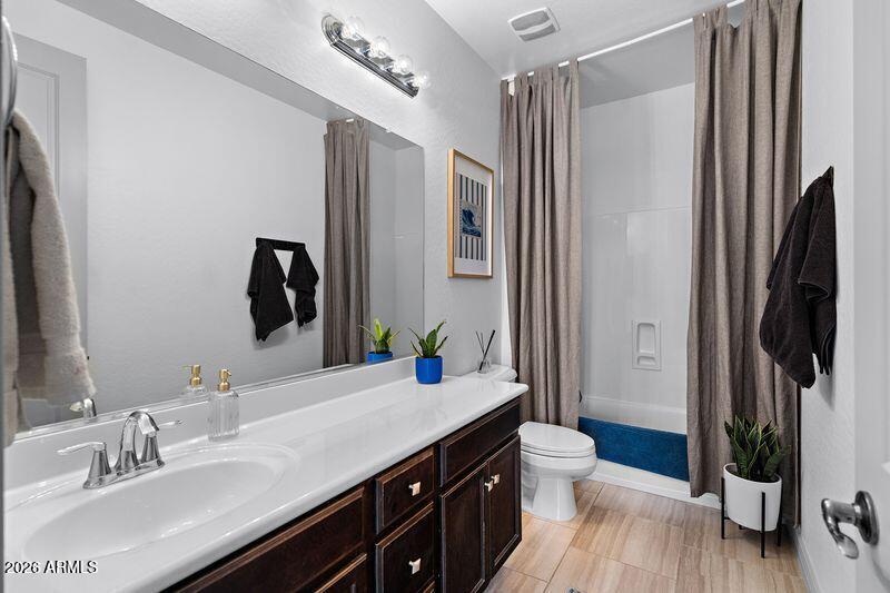 7871 South Stuart Avenue Gilbert, AZ 85298 - Photo 25 of 77 a bathroom with a double vanity sink toilet and shower