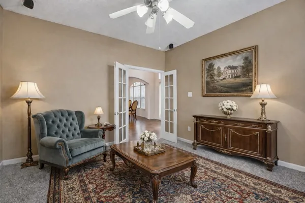 a living room with furniture and a chandelier