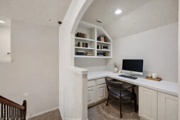 a view of a workspace with furniture