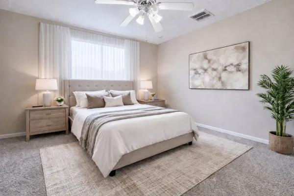 a bedroom with a bed and a painting on the wall