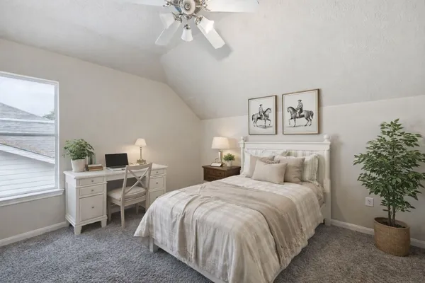 a bedroom with a bed and a potted plant