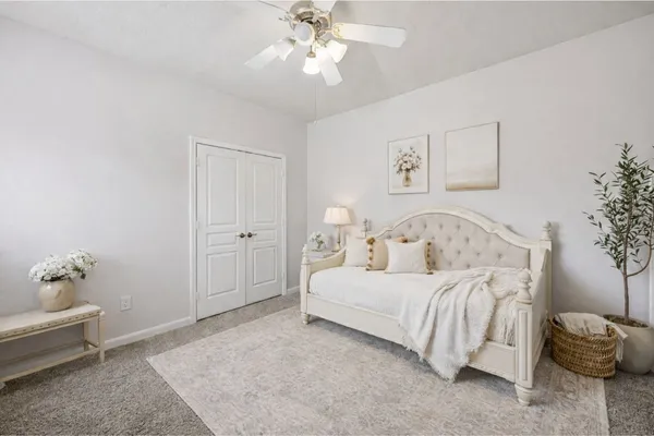 a bedroom with a bed and a chandelier