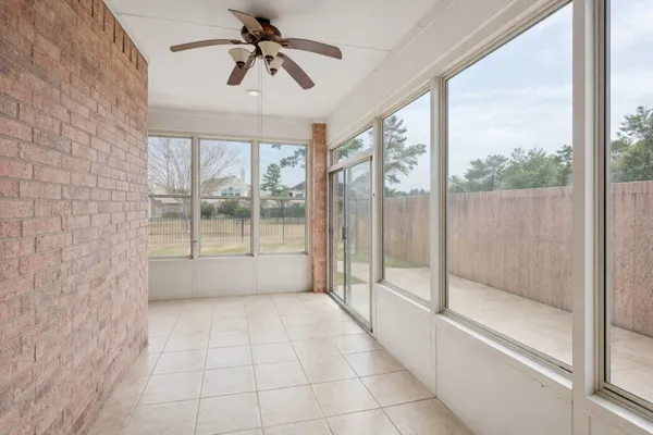 a view of an empty room and window ceiling fan