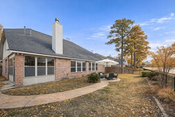 a front view of a house with a yard and mountain view