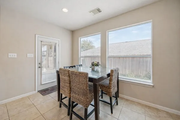 a dining room with furniture and window