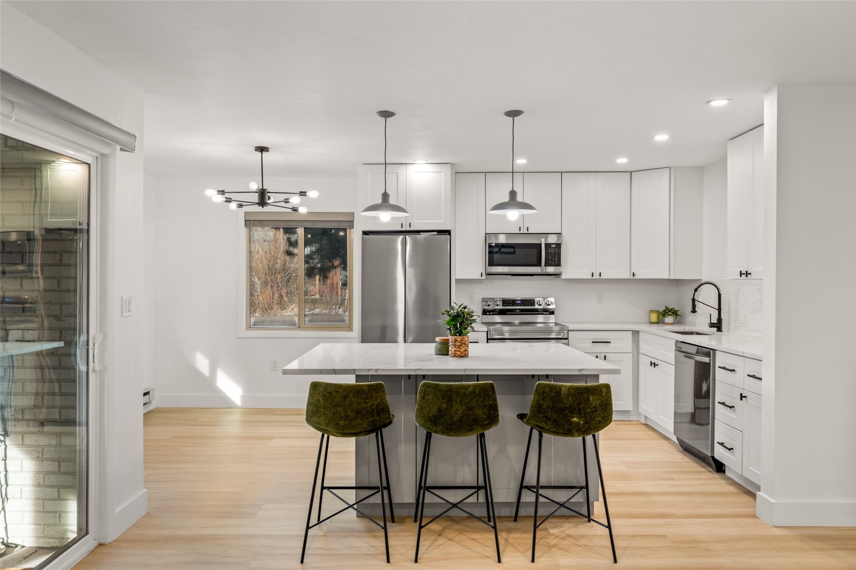 1375 Walton Creek Road, Unit 7 Steamboat Springs, CO 80487 - Photo 1 of 21 a kitchen with kitchen island wooden cabinets and stainless steel appliances