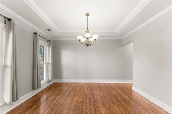 a view interior of a house with wooden floor chandelier and windows