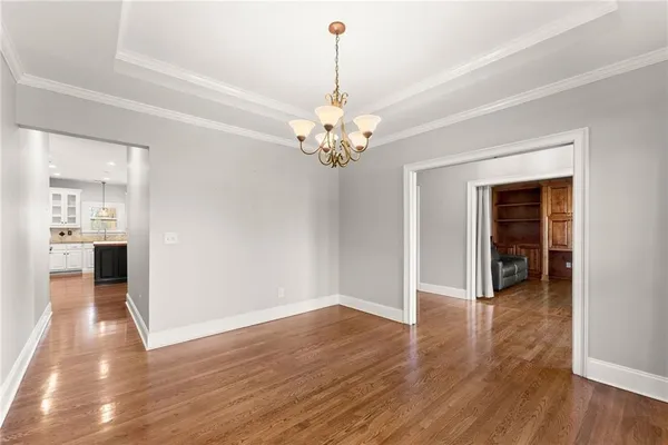 a view of a livingroom with wooden floor and a ceiling fan