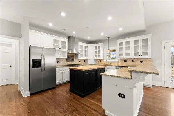 a view of a kitchen with a sink stainless steel appliances and cabinets