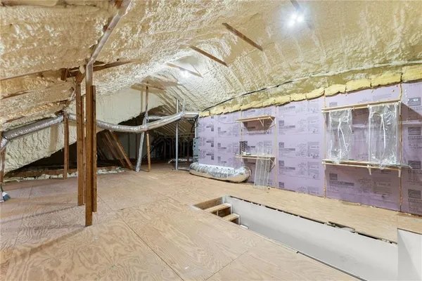 a view of a big room with wooden floor and a ceiling fan