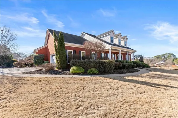 a front view of a house with a yard