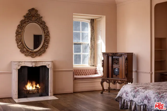 a living room with furniture a fireplace and a large window