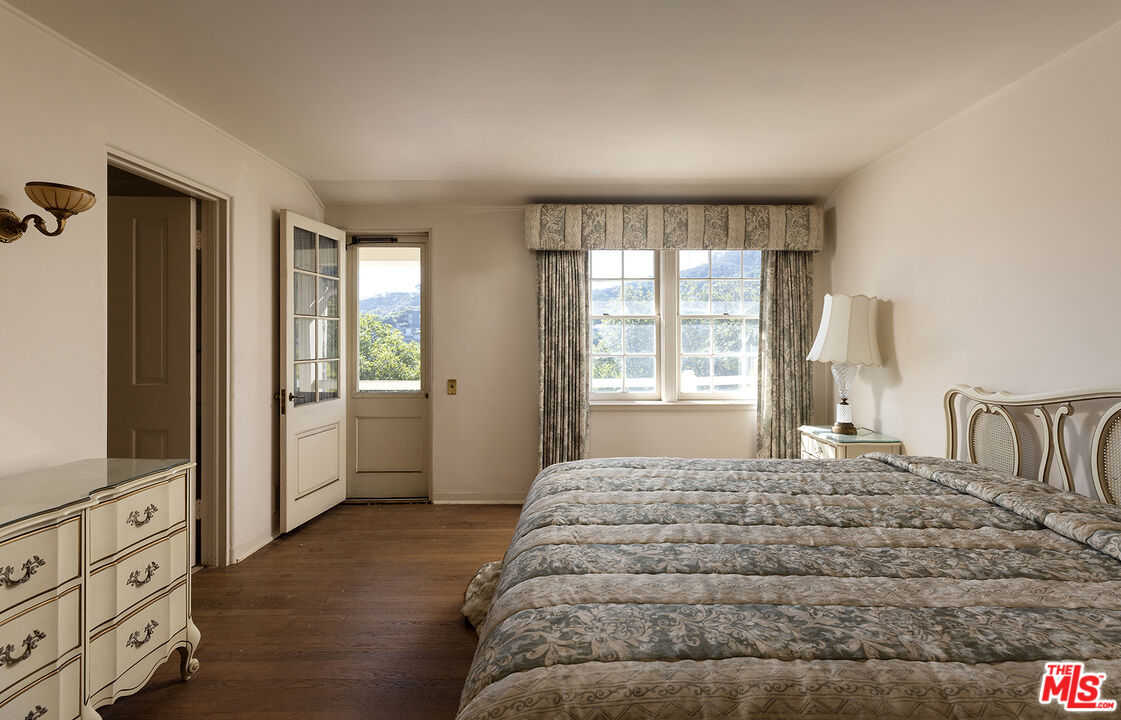 7141 Senalda Road Los Angeles, CA 90068 - Photo 16 of 26 a bed sitting in a bedroom next to a window