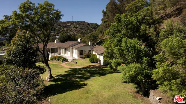 an aerial view of a house with a yard
