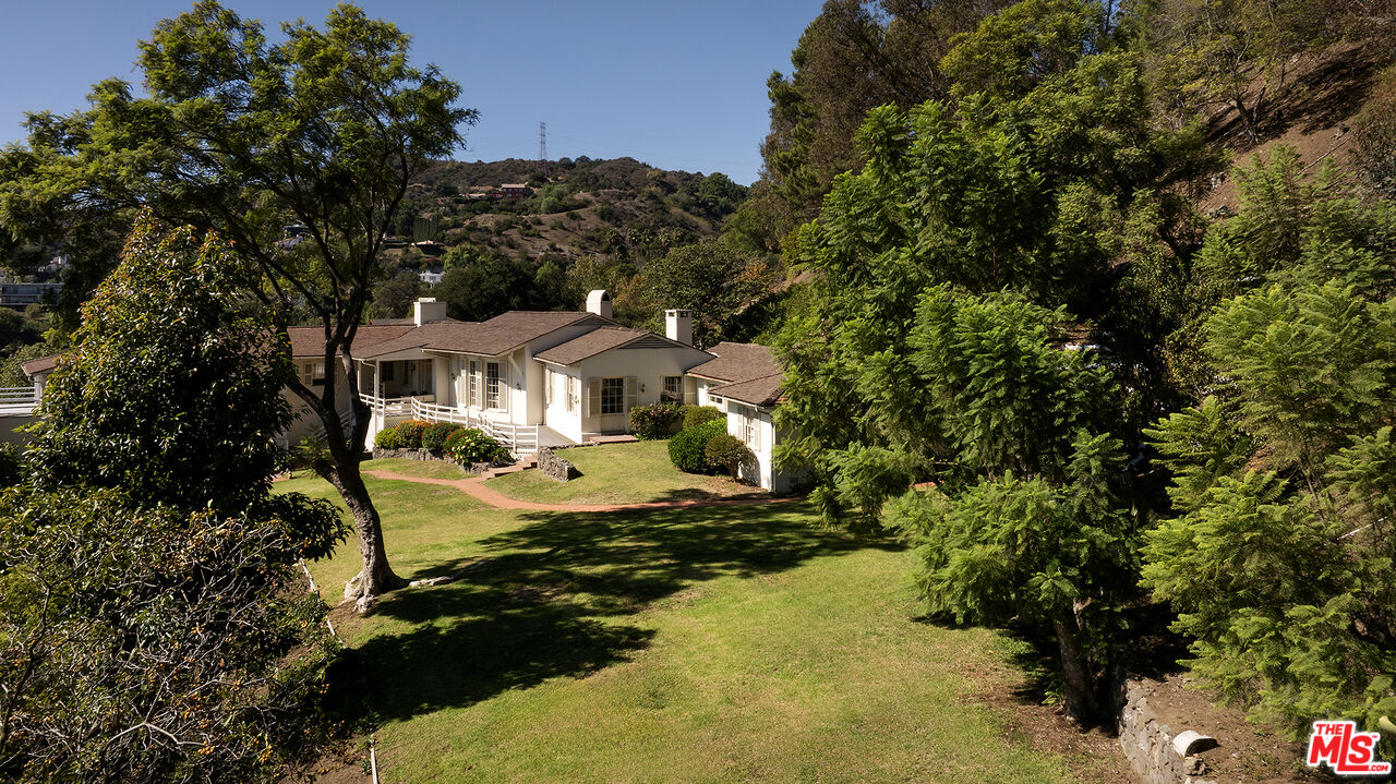 7141 Senalda Road Los Angeles, CA 90068 - Photo 22 of 26 a front view of a house with a yard