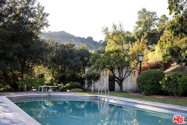 a view of house with car parked beside