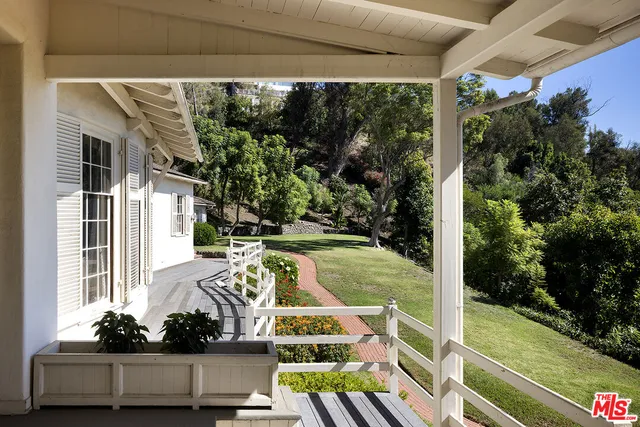 a view of a livingroom with wooden floor and furniture