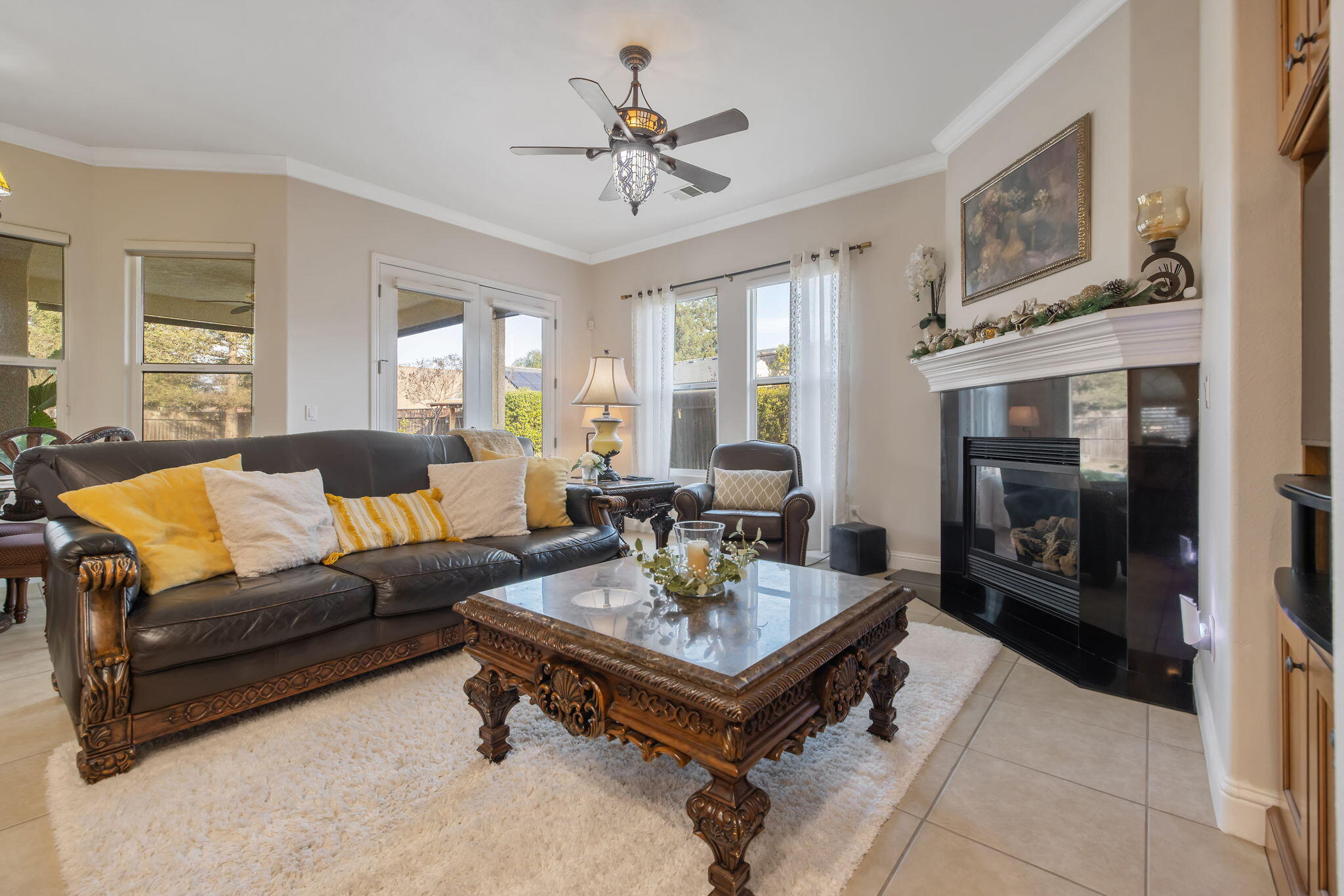 729 St Thomas Court Exeter, CA 93221 - Photo 18 of 66 a living room with furniture a fireplace and a chandelier