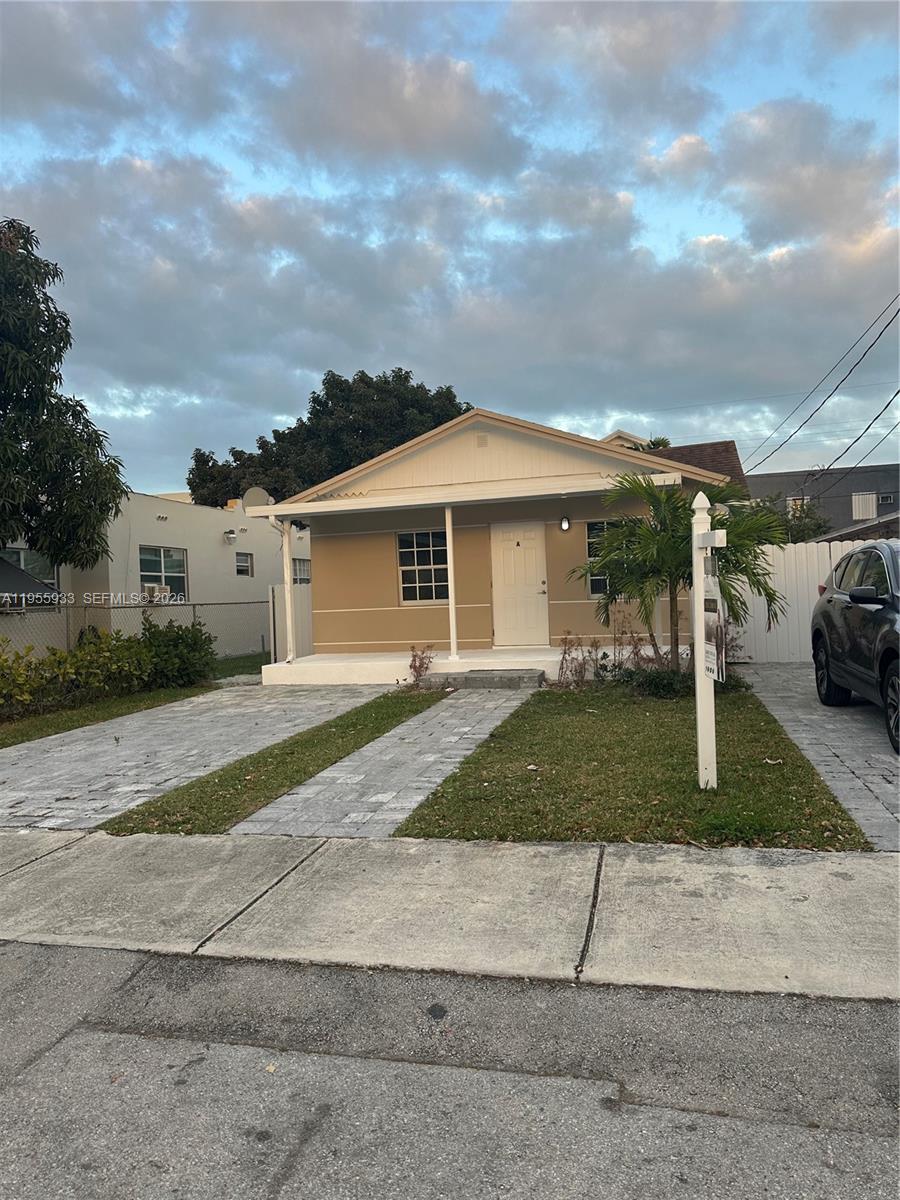 3123 Northwest 22nd Court, Unit A Miami, FL 33142 - Photo 3 of 18 a view of a white house next to a yard and road
