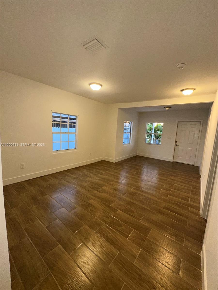 3123 Northwest 22nd Court, Unit A Miami, FL 33142 - Photo 8 of 18 a view of an empty room and window