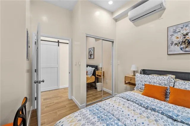 a bedroom with a bed and a rug