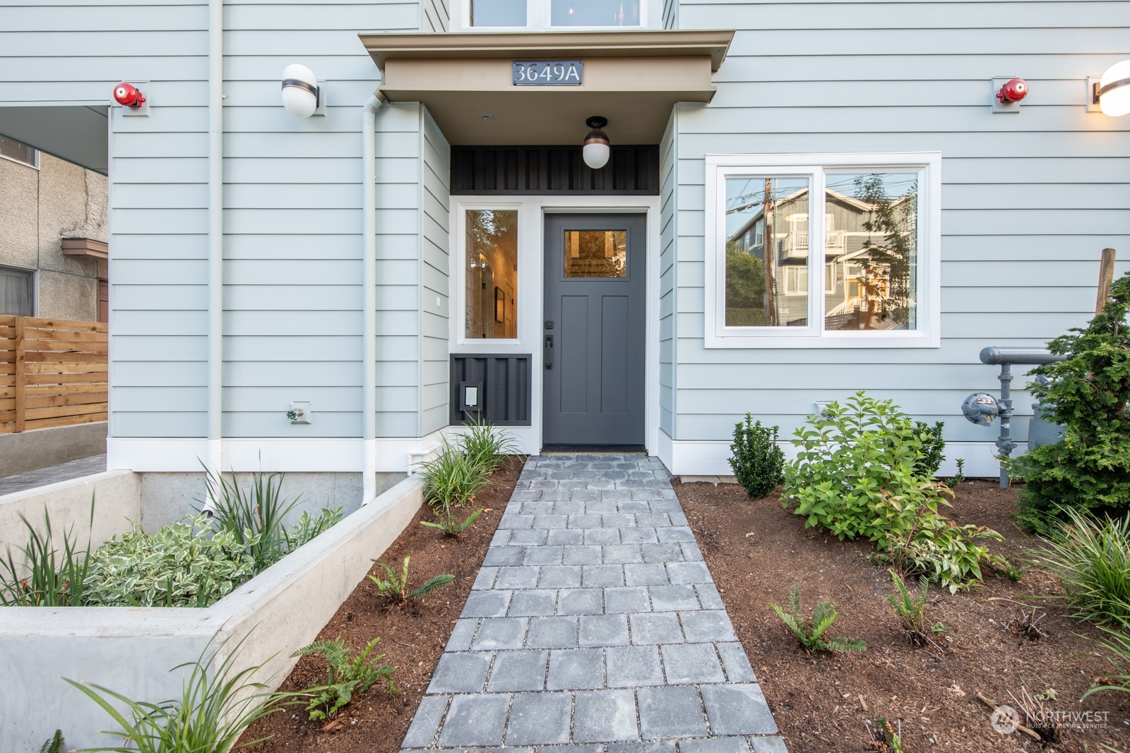 3649 Francis Avenue North, Unit A Seattle, WA 98103 - Photo 1 of 35 a view of a brick house with potted plants