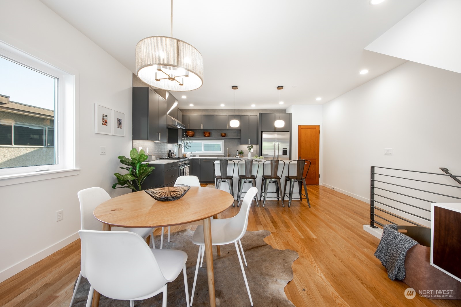 3649 Francis Avenue North, Unit A Seattle, WA 98103 - Photo 15 of 35 a view of a dining room with furniture wooden floor and chandelier