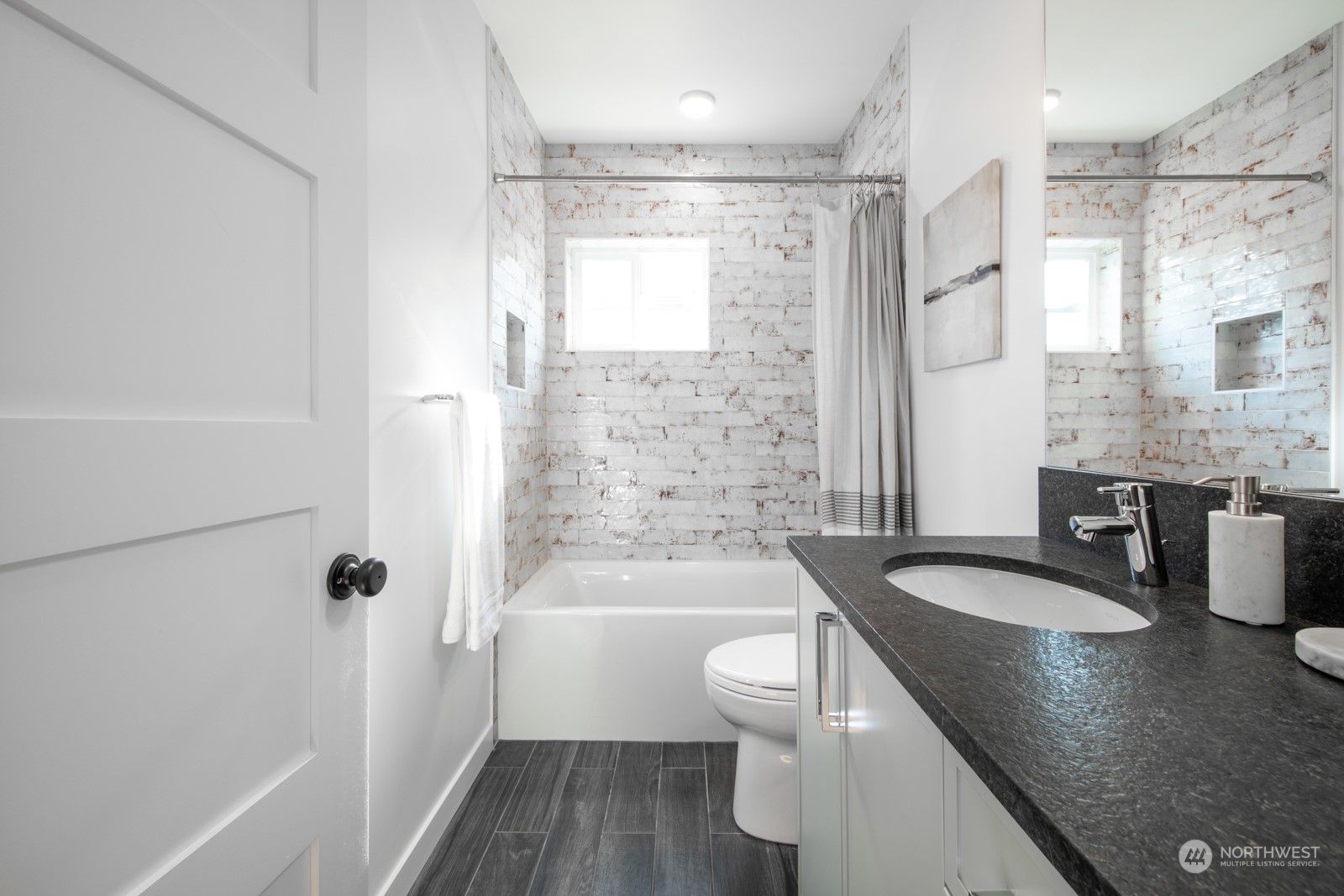 3649 Francis Avenue North, Unit A Seattle, WA 98103 - Photo 21 of 35 a bathroom with a granite countertop sink toilet and shower