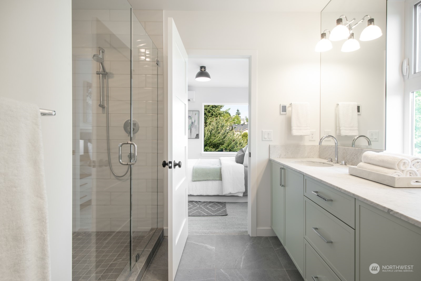 3649 Francis Avenue North, Unit A Seattle, WA 98103 - Photo 27 of 35 a bathroom with a double vanity sink and mirror