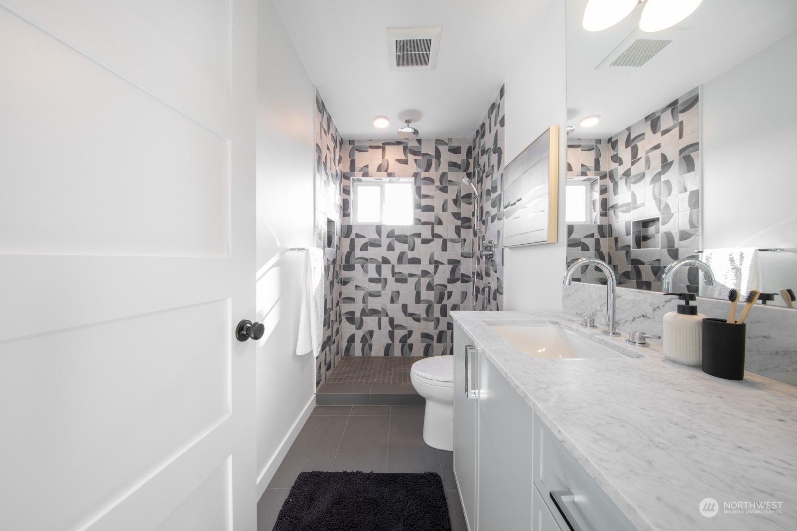 3649 Francis Avenue North, Unit A Seattle, WA 98103 - Photo 30 of 35 a bathroom with a sink a toilet and shower