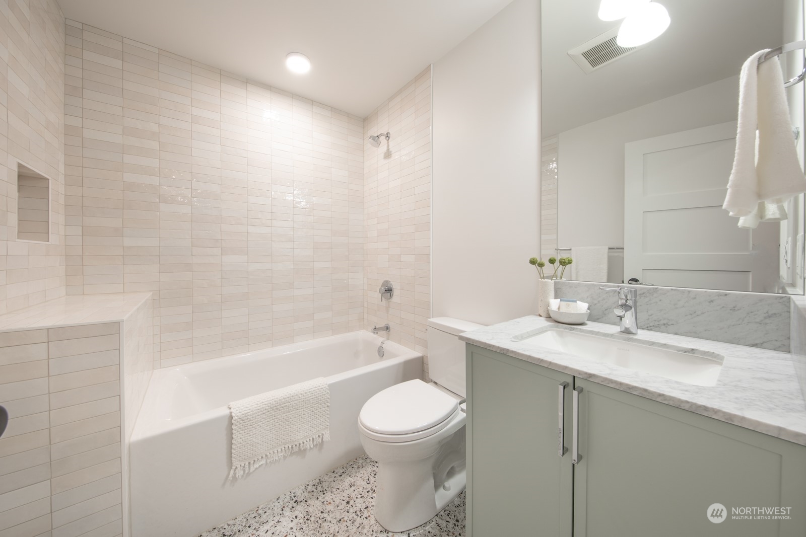 3649 Francis Avenue North, Unit A Seattle, WA 98103 - Photo 5 of 35 a bathroom with a bathtub shower sink vanity mirror and toilet