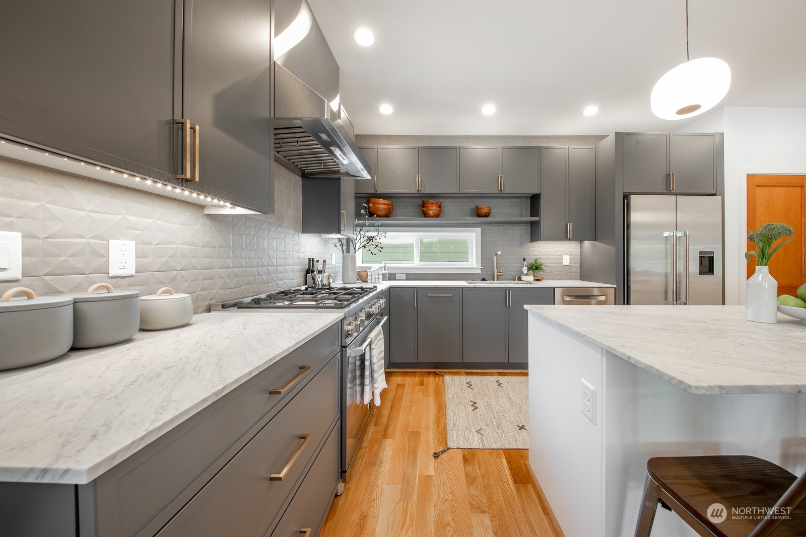 3649 Francis Avenue North, Unit A Seattle, WA 98103 - Photo 9 of 35 a kitchen with a sink a counter space stainless steel appliances and cabinets