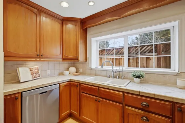 a kitchen with stainless steel appliances a sink and cabinets