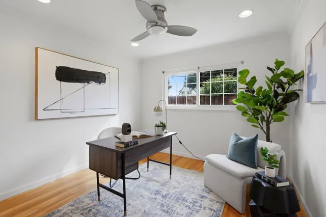 a living room with furniture potted plant and a window