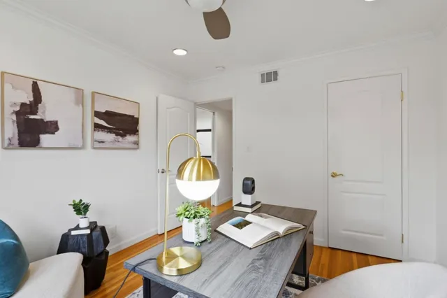 a living room with furniture and wooden floor