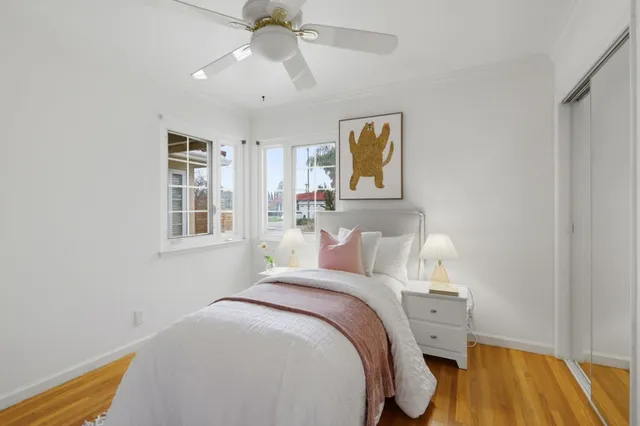 a bedroom with a bed and wooden floor