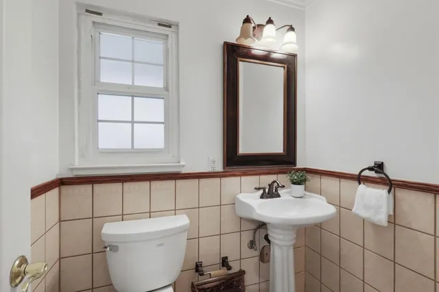 a bathroom with a sink toilet and mirror