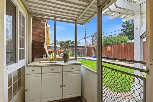 a kitchen with stainless steel appliances granite countertop a stove and a large window