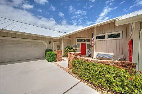 a front view of a house with a yard and a garage