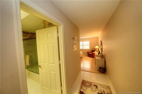 a living room with furniture and painting on the wall