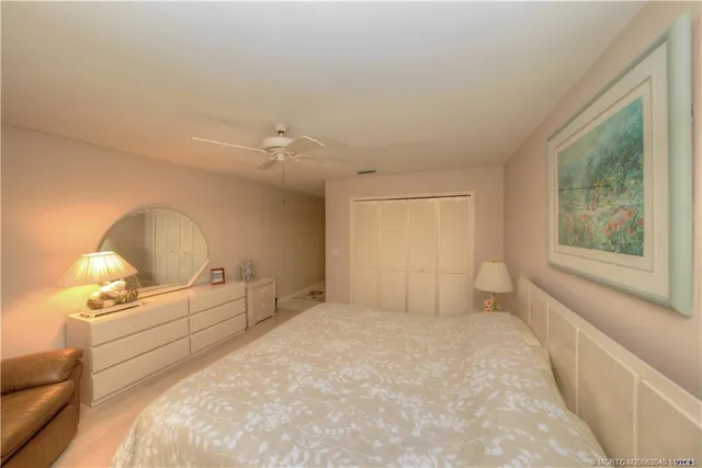 a bedroom with a flat screen tv on dresser and a flat screen tv