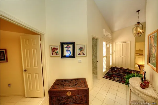 a view of swimming pool with outdoor seating and house in the background
