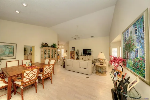 a living room with furniture fireplace and a large window