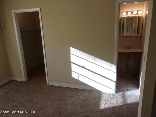 a view of hallway with closet and washing machine