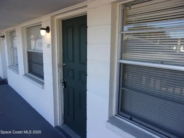 a view of a hallway with wooden cabinets