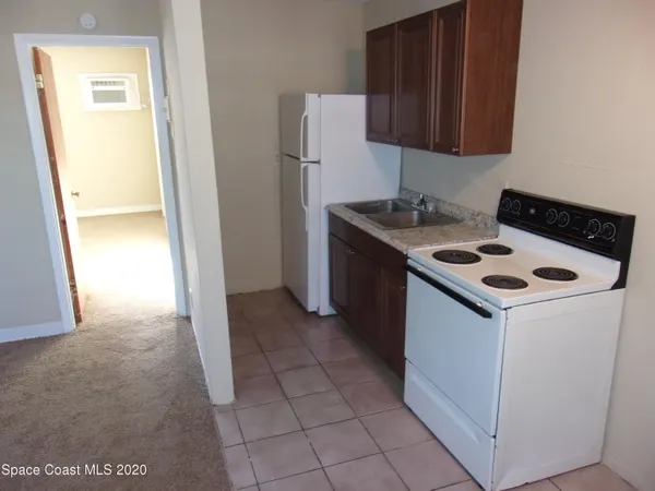 a kitchen with a sink and a stove top oven